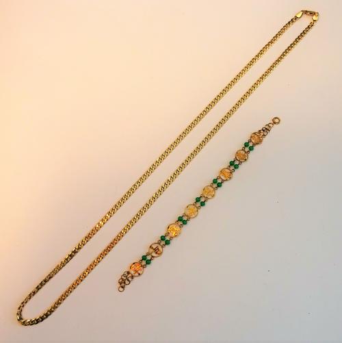 An Asian gold and pale green paste bead bracelet, decorated with character motifs, detailed 14k on a bolt ring clasp, gross weight 3.3gms and a 9ct go