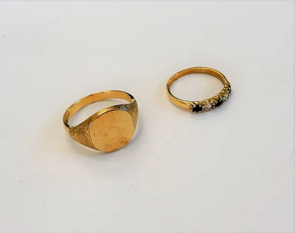 A 9ct gold signet ring, decorated with bark textured shoulders, ring size V and a half and a 9ct gold, sapphire and colourless gem set five stone ring