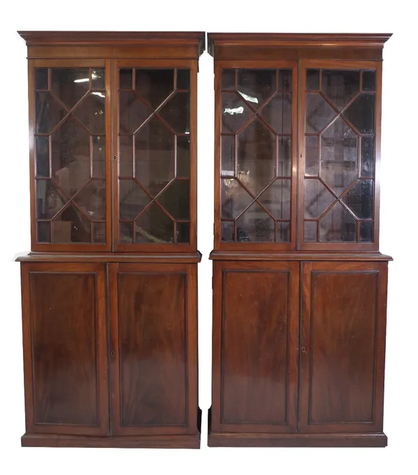 A pair of mahogany bookcase cabinets, late Victorian incorporating earlier elements, each with astragal moulded doors over cupboard base, 95cm wide x