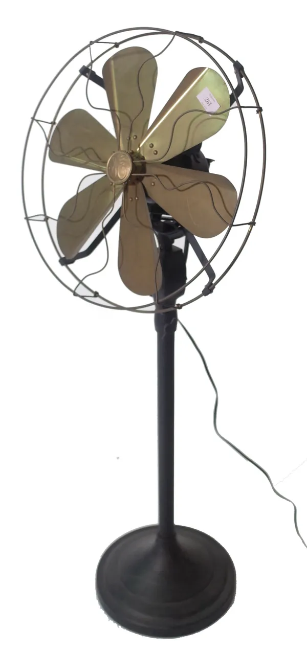 A 1950s style electric fan with gilt metal blades and an ebonised metal body, 110cm high. Provenance; property from the late Sir David Tang This lot h