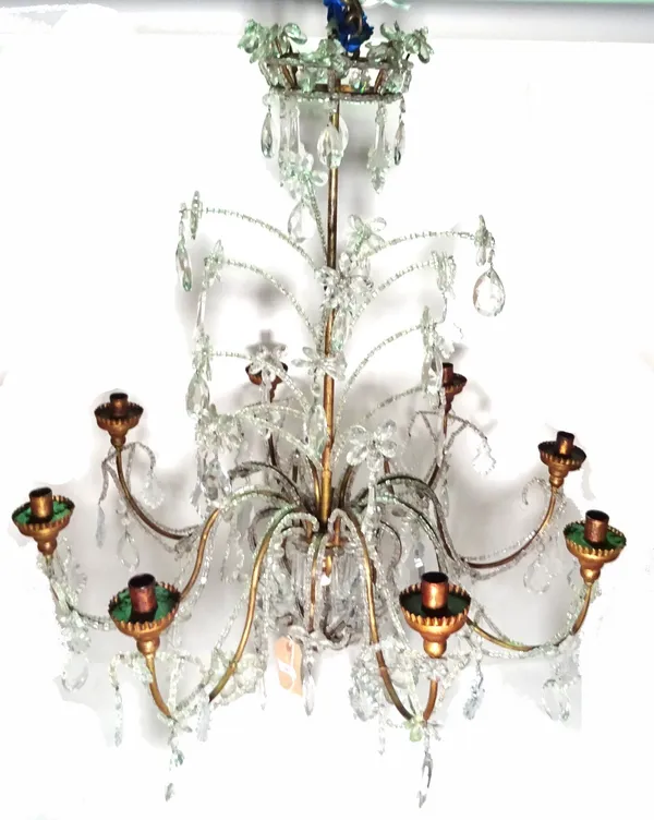 A modern gilt metal and glass eight branch chandelier, with foliate 'crown' surmount over a central metal shaft issuing eight swan neck branches festo