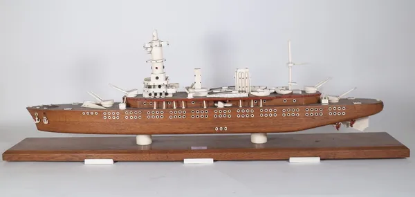 An oak and ivory mounted scale model of a war ship, circa. 1900, raised on a chamfered oak plinth and six ivory feet, 100cm wide. Provenance; property