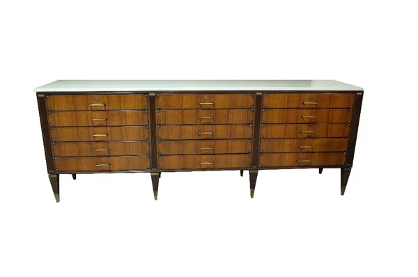 A late 19th century French Empire style sideboard, with white marble top over fifteen drawers on tapering supports, 242cm wide x 52cm deep, x 91cm hig