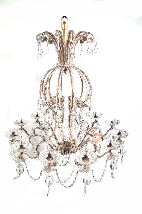 A modern gilt metal and glass twelve branch chandelier of open cage 'balloon' form, the frame and branches festooned with glass beads, hung all over w