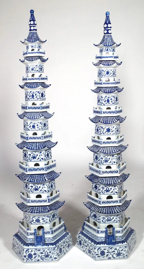 A pair of modern Chinese porcelain pagodas, blue and white decoration against a stepped hexagonal body, unsigned, 120cm high. (2) Provenance; property