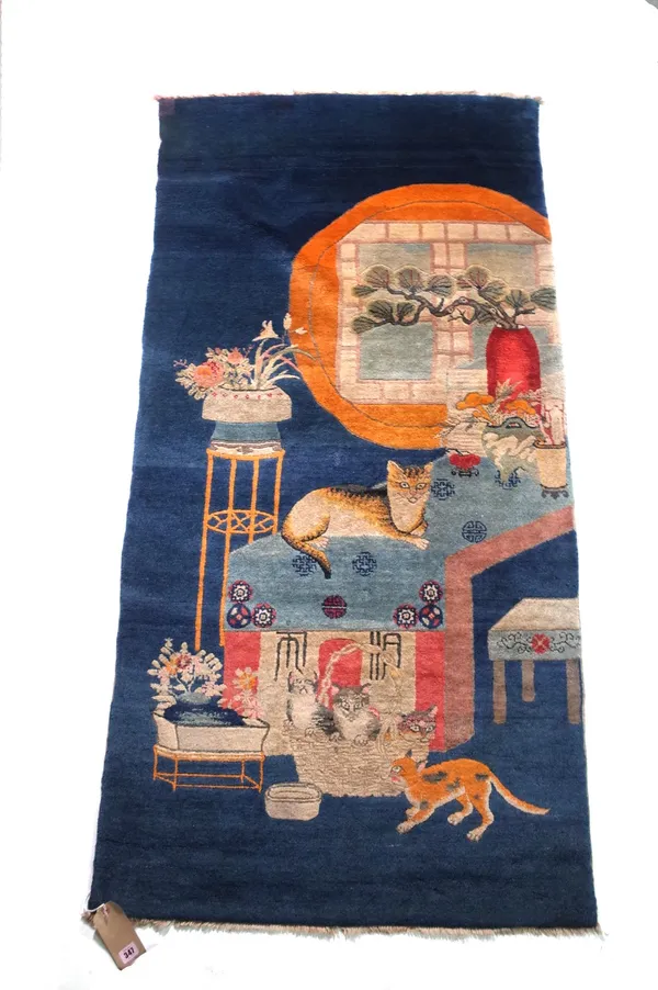 A 20th century Chinese short runner, mid-war or later, blue ground with cat and kitten decoration, 180cm long x 92cm wide. Provenance; property from t