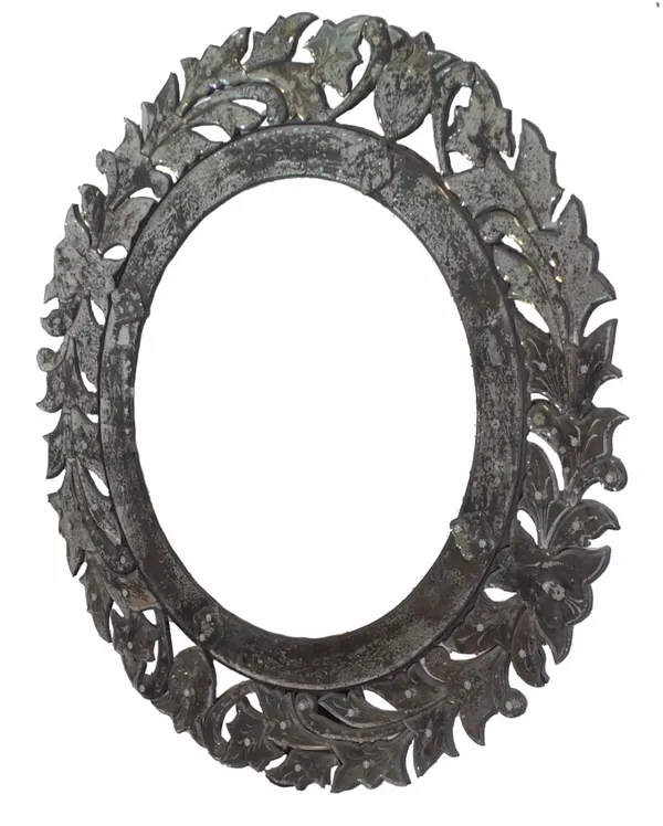 A late 20th century Venetian style circular mirror, of elaborate scrolling circular form, bevelled plate within pierced scrolling leaf border, 126cm d