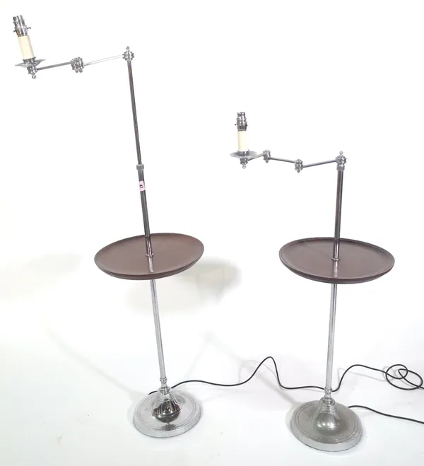 A pair of modern chromed adjustable standard lamps with central circular tier over a weighted circular foot, maximum height approx. 150cm, (2). Proven