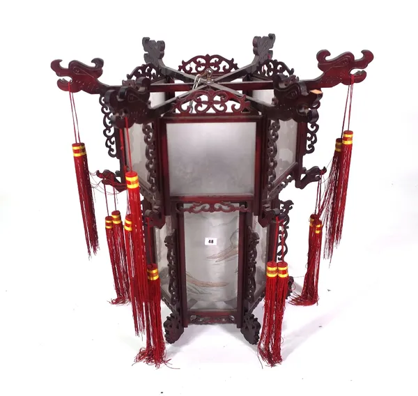 A modern Chinese hanging lantern with carved hardwood octagonal frame, glass panels and silk shades beneath, 75cm high x 80cm wide.  Provenance; prope