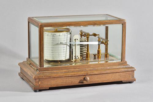 AN EDWARDIAN OAK CASED BAROGRAPHBy Negretti and Zambra, London, No. 30390, circa 1900The case with five bevelled glazed panels, the mechanism with eig