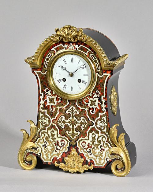 A NAPOLEON III ORMOLU-MOUNTED BOULLE MANTEL CLOCKCirca 1860The arched case with gadrooned edge above a circular white enamel dial with pierced moon h