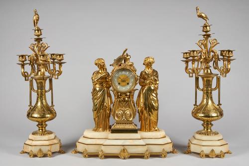 A FRENCH GILT BRASS AND ONYX GARNITURECirca 1900The clock modelled with a figure of Ceres, emblematic of summer, and another emblematic of painting, s