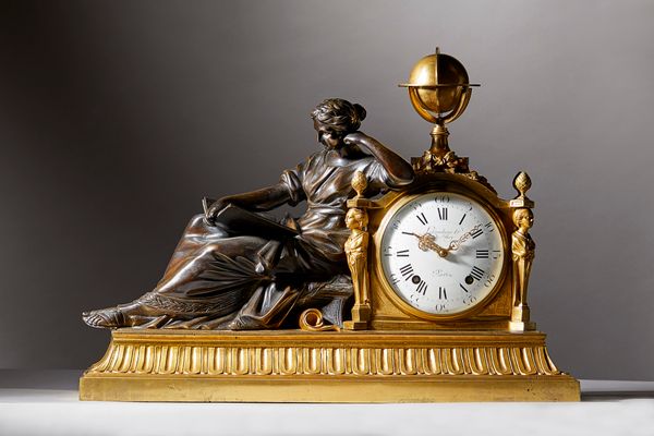 A large French ormolu and patinated bronze striking eight-day figural mantel clock (Pendule a la Geoffrin)After the model by Laurent Guiard, probably