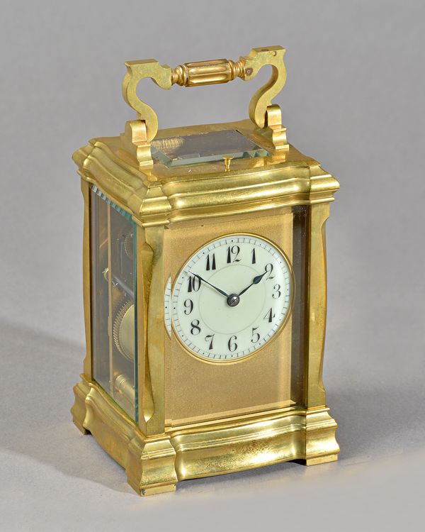 A FRENCH BRASS REPEATING CARRIAGE CLOCKBy Henri Jacot, No. 18535, circa 1914In a stylised case, the top engraved with a presentation dated 1914, with