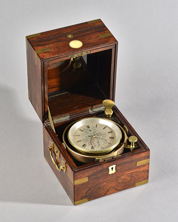 A Victorian rosewood and brass-bound chronometer By F. W. Clerke, London, No. 539Circa 1860, (one case key and one key)The three-tier case with brass