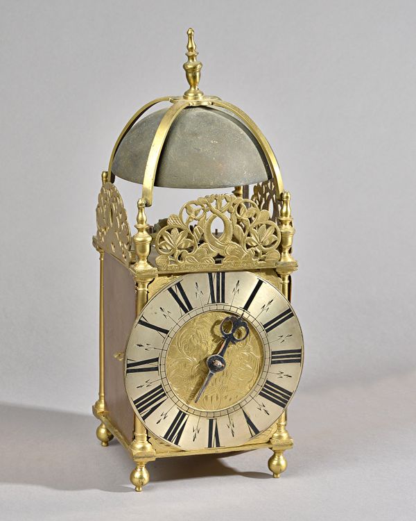 A BRASS LANTERN CLOCKSigned John Broocksted, TunbridgeOf usual form, surmounted by a bell with strapwork and turned finial, above four turned finials