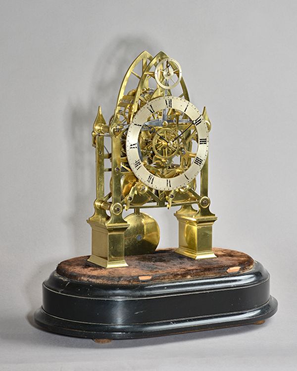 A Victorian brass twin train skeleton clockThe lancet-shaped frame with silvered strike/silent subsidiary ring, above the silvered chapter ring with R