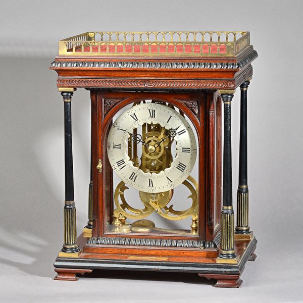 A MAHOGANY CASED SKELETON TIMEPIECEThe rectangular case with a pierced brass gallery, above moulded and carved pediment, on four slender ebonised upri