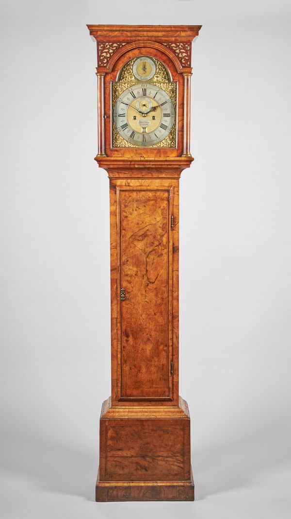 A GEORGE I WALNUT LONGCASE CLOCKBy James Drury, London, circa 1720The case with a moulded pediment above fretted spandrels and arched glazed door with