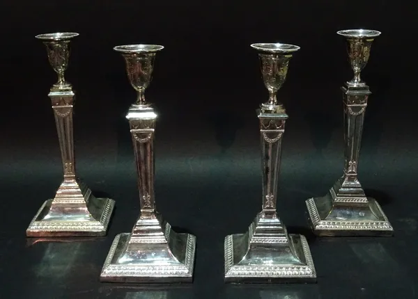 A group of four Victorian silver plate on copper candlesticks, with tapering columns and urn shaped capitals. (4)  Provenance; property from the late