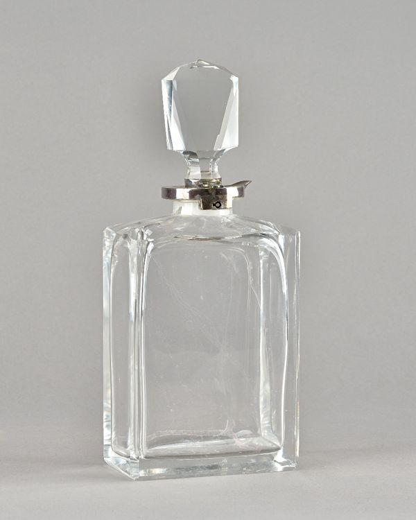 An Edward VII silver mounted cut glass lockable decanter, (lacking key), the silver collar with pouring spout, London 1905.  Provenance; property from