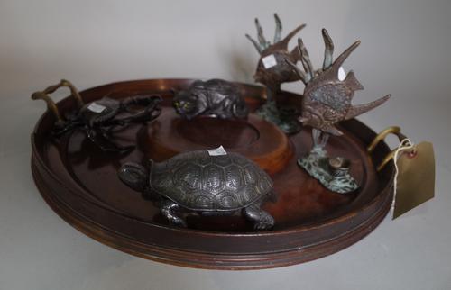 A Victorian mahogany twin handle circular tray, 49cm diameter, a pair of bronze candlesticks formed as angel fish and three metal inkwells formed as a
