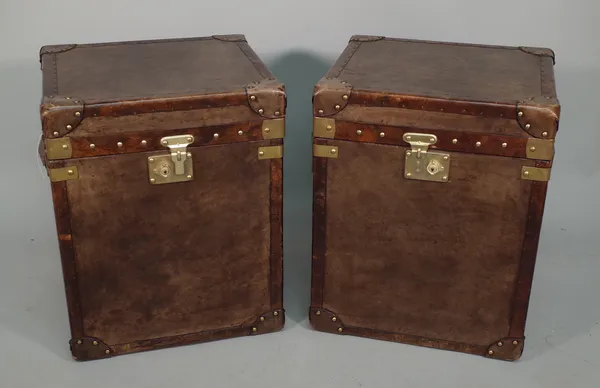 A pair of two-tone leather covered trunks of recent manufacture, each with gilt metal hardware and lined interior, 57cm x 45cm x 41cm (2).