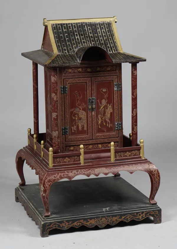 A Chinese style wooden lacquered shrine, 20th century, gilt/red of square pagoda form on cabriole supports and an ebonised plinth base. 110cm high