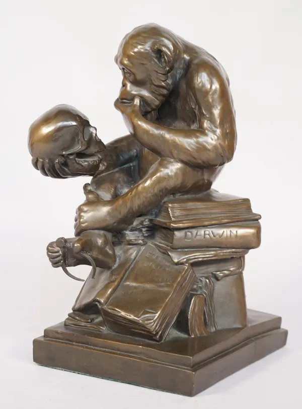 A modern composite bronze, 'Darwin' depicting a chimpanzee contemplating a human skull on a mass of books, on a plinth base, 31cm high.