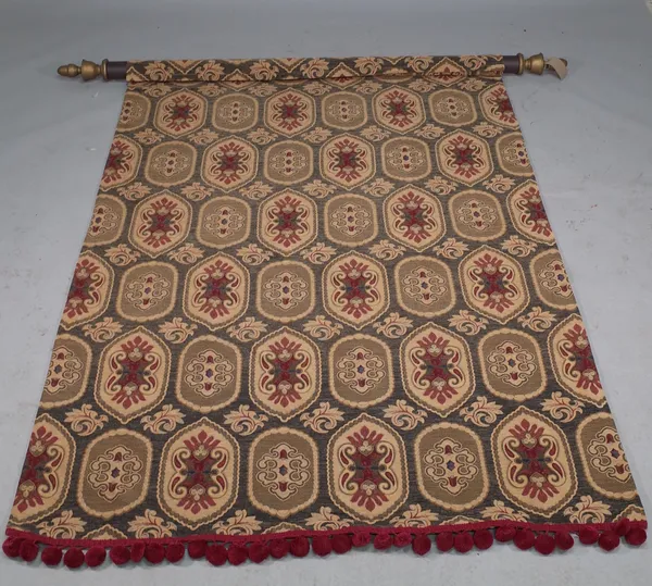 A 19th century style textile wall hanging panel of foliate geometric design, on a giltwood pole with brass wall brackets, pole 185cm wide.