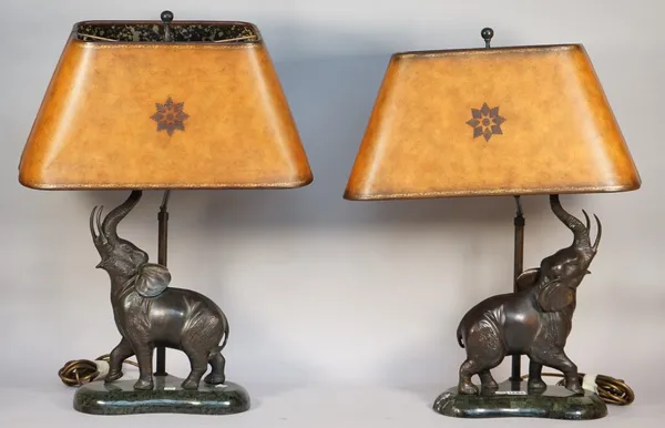 A pair of modern composite bronze elephant table lamps, each with brown leather shades, 64cm high overall, (2).