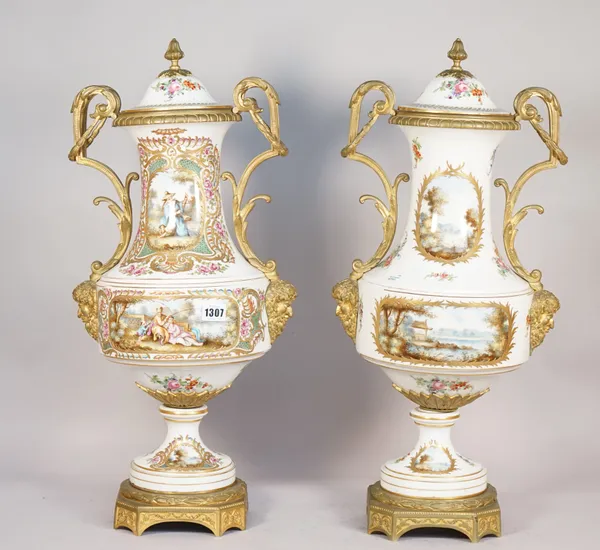 A pair of Sevres-style porcelain and gilt metal mounted vases and covers, late 20th century, each painted with figures against a landscape with Bacchu