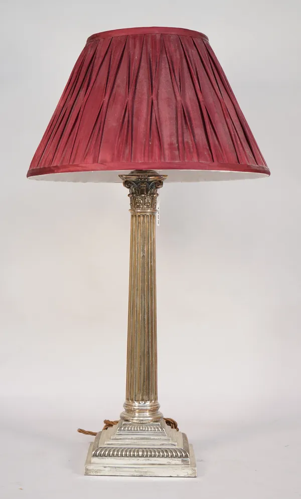 A silver table lamp, hallmarked Goldsmiths and Silversmiths, London 1901, of Corinthian column form on a stepped square base, with pleated shade, 63cm