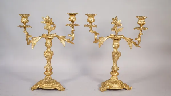 A pair of Louis XV style gilt metal twin branch candelabra, each raised on three scroll feet, 38cm high, (2).