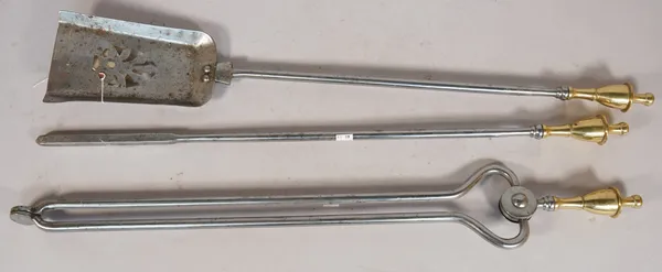 A set of three Victorian steel and brass fire irons, with pierced plate and brass urn shaped handles, shovel 66cm long, (3).