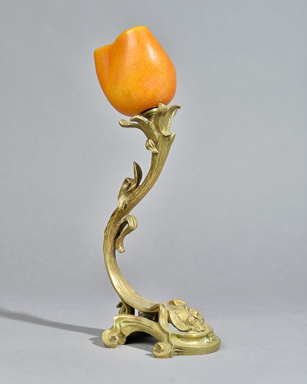 A Daum Art Nouveau glass and gilt bronze table lamp, circa 1900, the cased glass orange shade of foliate form, signed 'DAUM NANCY' over a gilt bronze