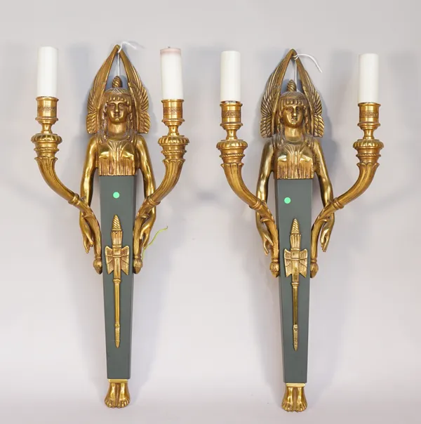 A pair of Empire style figural two branch wall appliques, 20th century, each with winged female surmount over a green painted tapering square backplat