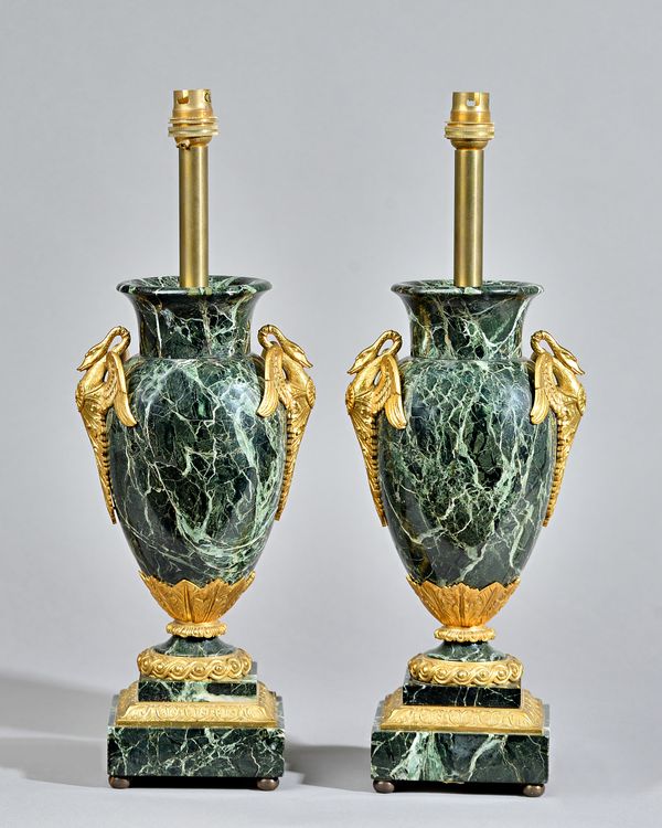 A pair of verde marble gilt metal mounted vase table lamps, circa 1900, each of urn form with twin swan cast handles, over a stepped square base and f