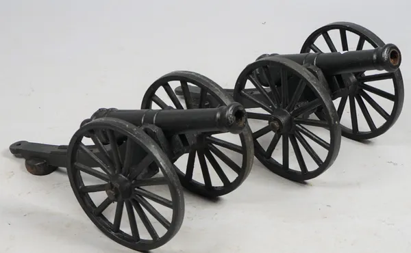 A pair of modern cast iron scale model cannon, each with spoked wheels and turned barrel, 71cm, (2).