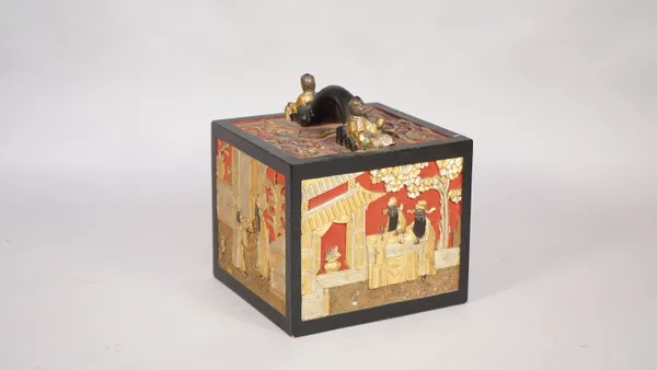 A Chinese Mahjong set, early 20th century, with bone pieces and ornately carved wooden case, 19cm wide.