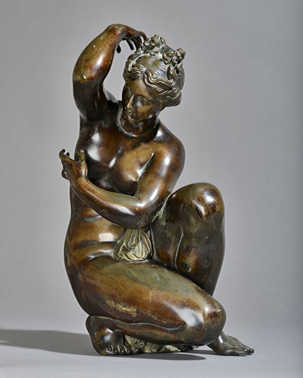 After the antique, bronze model of a crouching Venus, late 19th century modelled seated on a verdigris patinated bronze turtle, (lacking base), 37cm h