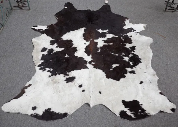 A modern cow hide rug, 220cm.