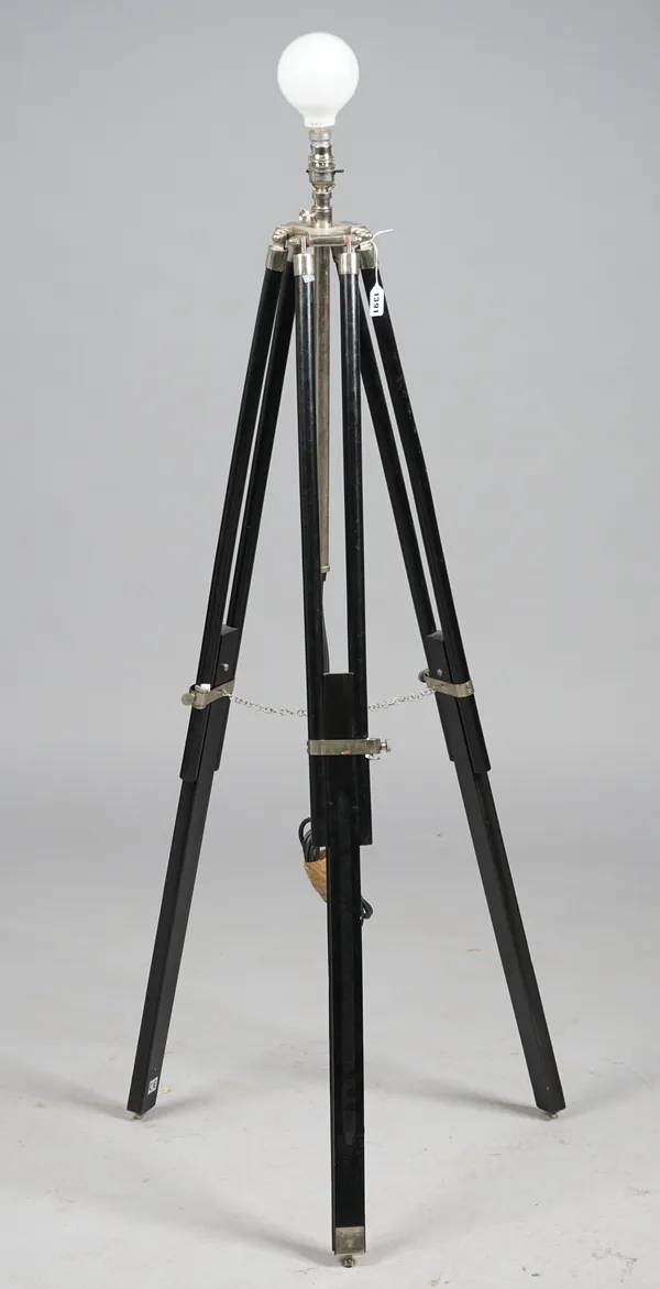 A modern ebonised wood and white metal adjustable floor lamp, raised on adjustable tripod supports with a black shade.