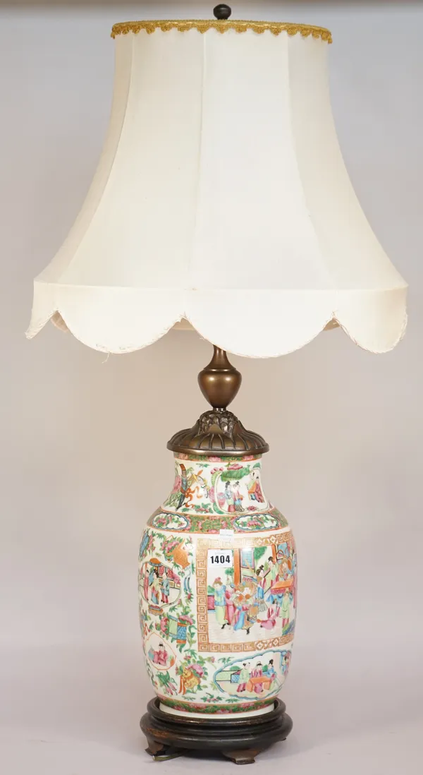 A Cantonese porcelain vase table lamp, late 19th century, with metal mounts, on a circular wooden base, with shade, the vase 36cm high.