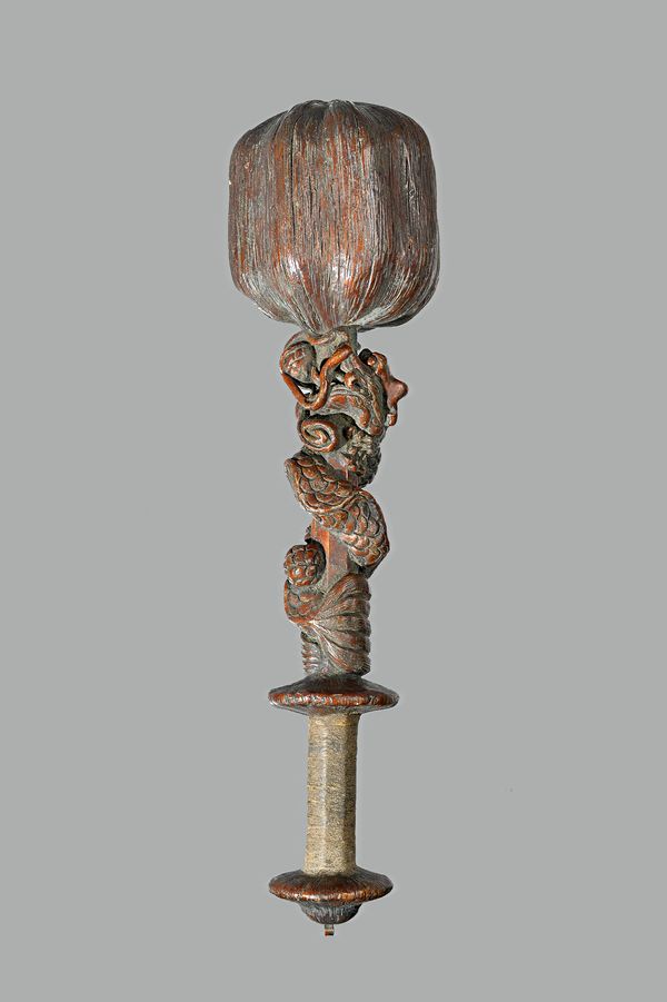 Tribal interest; an unusual South East Asian hardwood club, the bulbous head of naturalistic form, the octagonal shaft carved in relief with a dragon