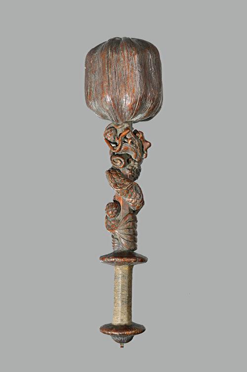 Tribal interest; an unusual South East Asian hardwood club, the bulbous head of naturalistic form, the octagonal shaft carved in relief with a dragon