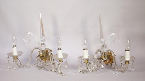 Two sets of four cut moulded and brown glass twin branch wall lights, parts 19th century and later parts, the first set with slice cut scrolling arms