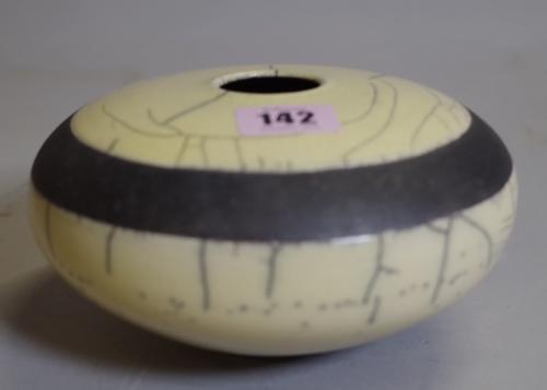 A 20th century Raku studio pottery vase with craquelure decoration, indistinctly signed to the base, 16cm wide.