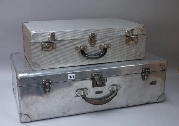 Two aluminium suitcases, the largest 74cm x 44cm x 24cm.