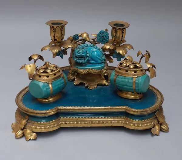 A Chinese porcelain and ormolu mounted Louis XV style encrier, mid-19th century, the central Dog of Fo flanked by twin candle sconce and twin barrel f